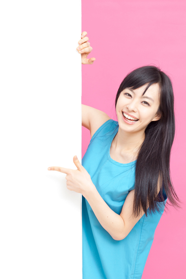 Cute woman pointing billboard